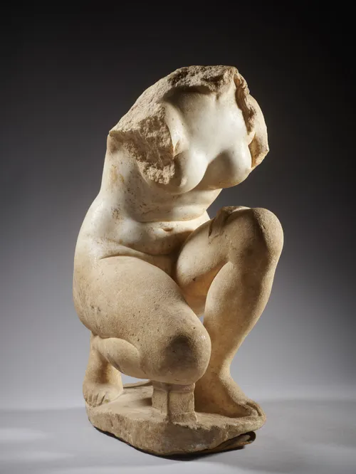 A Roman marble crouching Aphrodite,