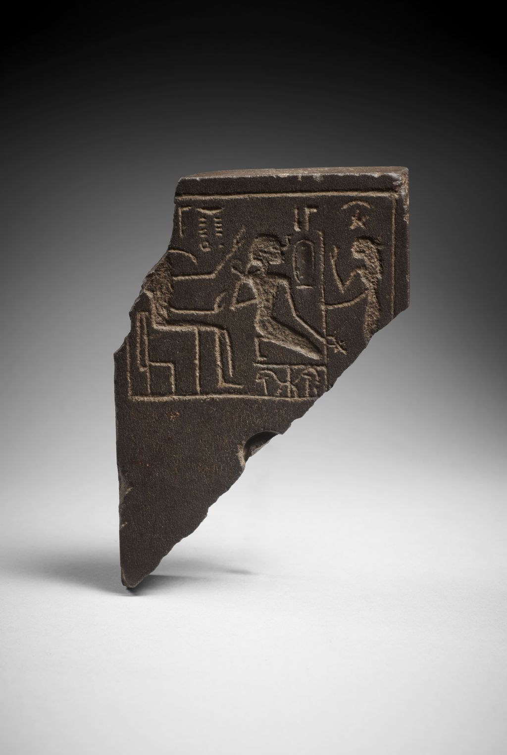 An Egyptian fragmentary basalt scribal palette,